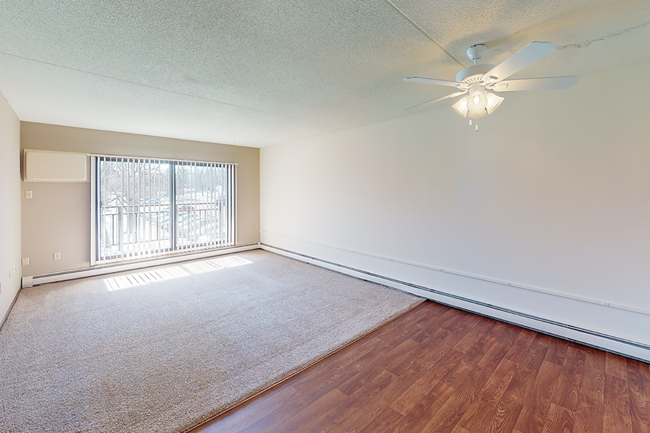Living room with carpet & dining room with laminate flooring at apartments for rent in Inver Grove Heights, MN