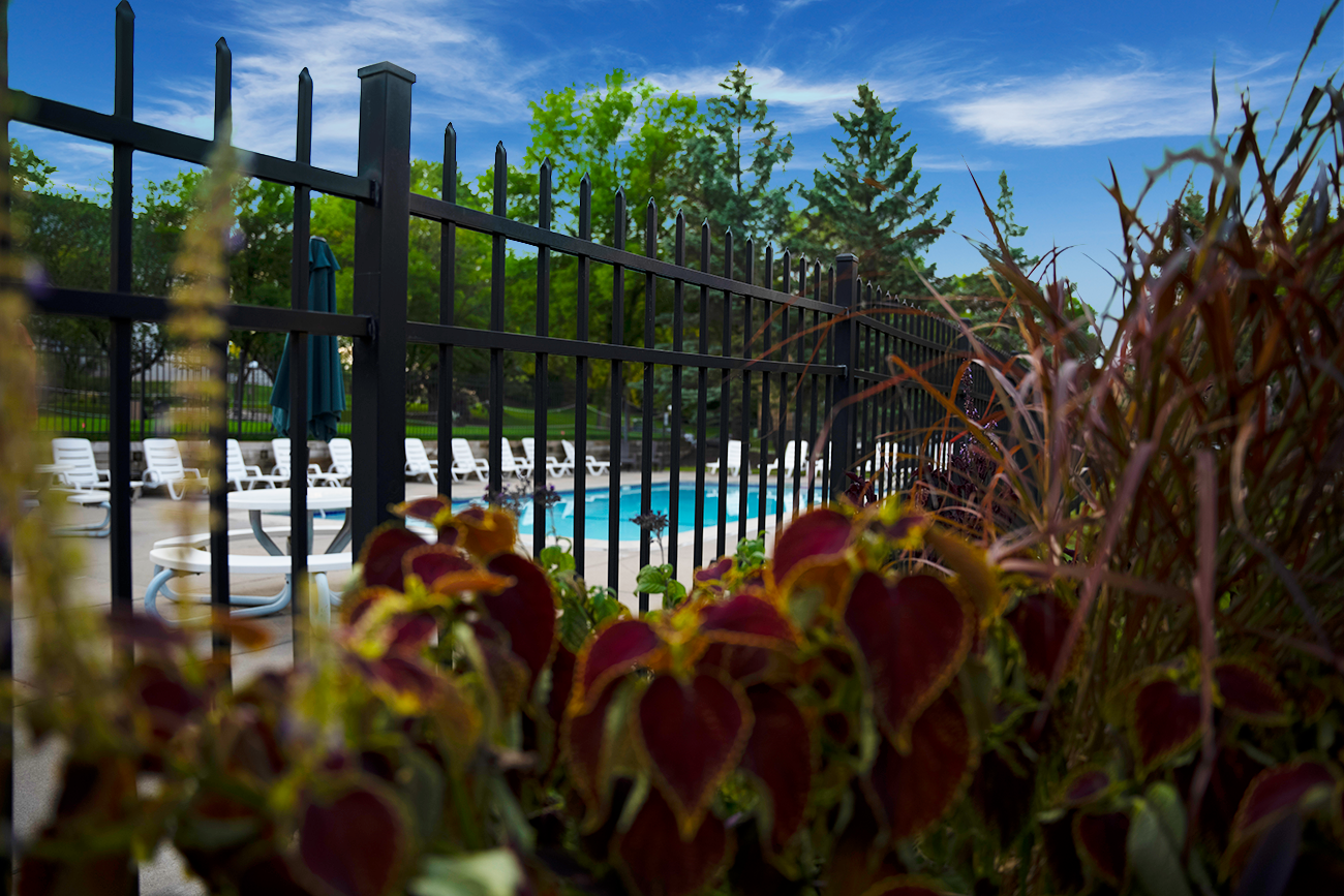 Outdoor swimming pool with lush landscaping at apartments for rent in Inver Grove Heights, MN