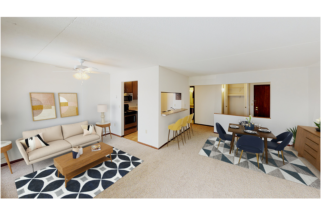 Open-concept living room & dining room with breakfast bar at apartments in Inver Grove Heights, MN